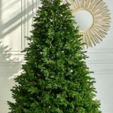 Artificial Christmas green tree without decorations on a metal stand isolated on a white background